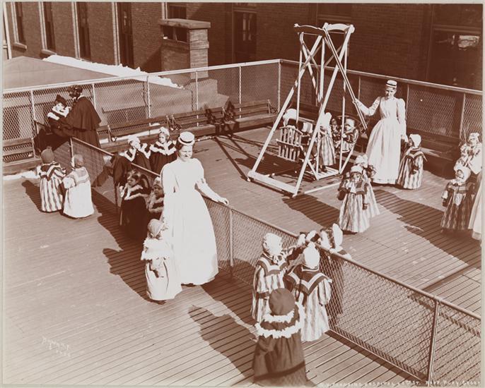 The dedicated efforts of social reformers, including widows, the unmarried, and religious sisters, resulted in the establishment of Foundling Houses, where the children of unwed mothers received care, education, and moral formation. This photograph depicts foundlings and nurses in the rooftop playground of the New York Foundling Hospital, established in 1869. (Public Domain)