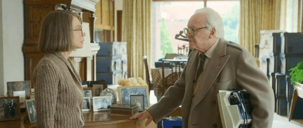 Grete Winton (Lena Olin) exhorting husband Nicholas Winton (Anthony Hopkins) to please throw out that useless typewriter he's salvaged, in "One Life." (Warner Bros.)