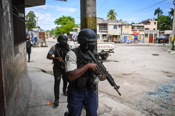 Police officers patrol a neighborhood amid gang-related violence in downtown Port-au-Prince on April 25, 2023. (Richard Pierrin/AFP via Getty Images)