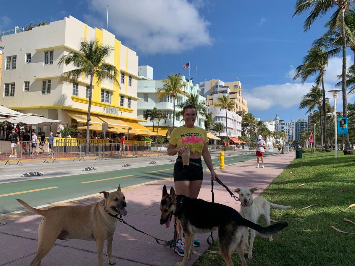 Miami Beach resident Cora Earl walking her dogs on Ocean Drive in Miami Beach, Fla. on March 15, 2024. (T.J. Muscaro/The Epoch Times).