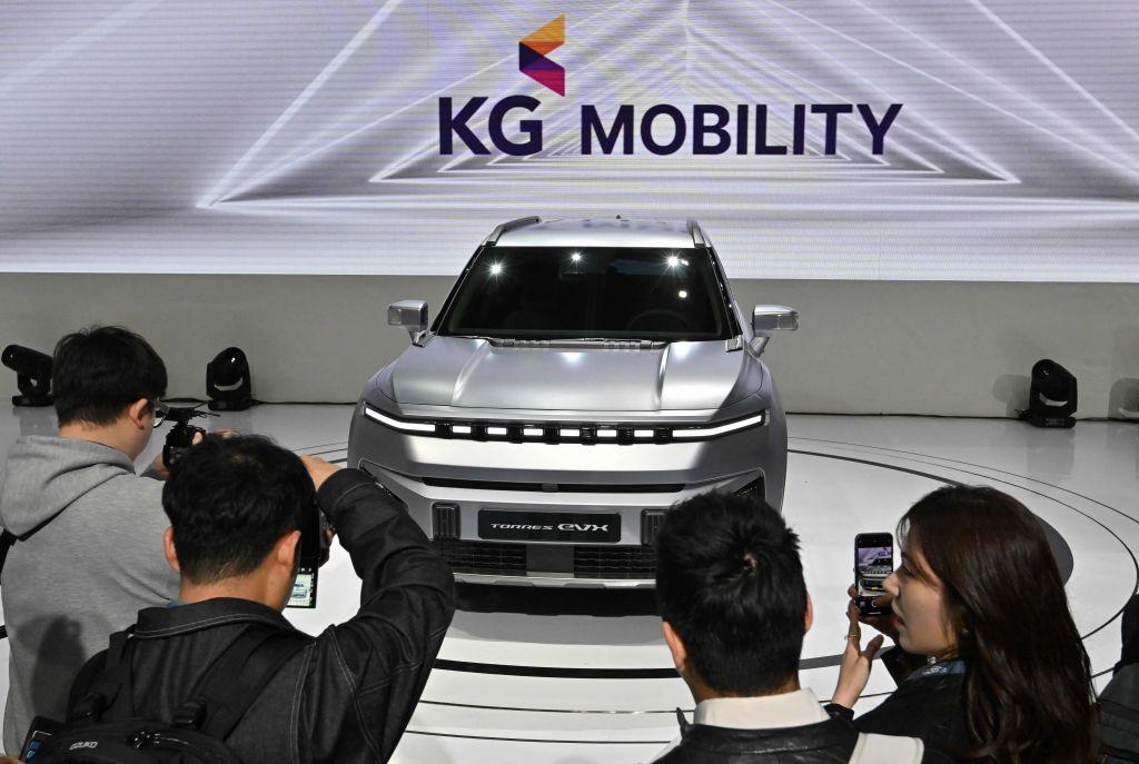 Visitors look at the KG Mobility Torres EVX electric vehicle during a press preview of the 2023 Seoul Mobility Show at the KINTEX exhibition hall in Goyang, on March 30, 2023. (Jung Yeon-je / AFP via Getty Images)