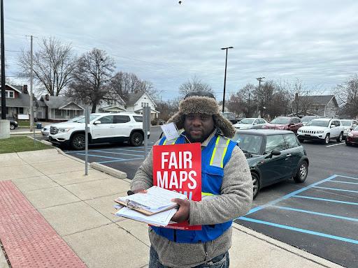A man named Mike stands outside Whittier Elementary School, one of the polling places on Toledo, Ohio, on March 19, 2024, looking to collect signatures to challenge the state’s redistricted map. (Jackson Richman/Epoch Times)