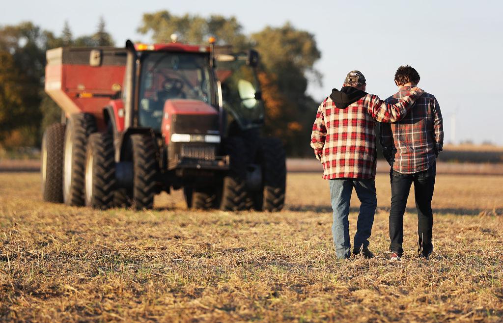 Roy Bardole walks with his grandson Gabe Bardole during the soybean harvest at the Bardole & Son's Ltd farm in Rippey, Iowa, on Oct. 14, 2019. (Joe Raedle/Getty Images)