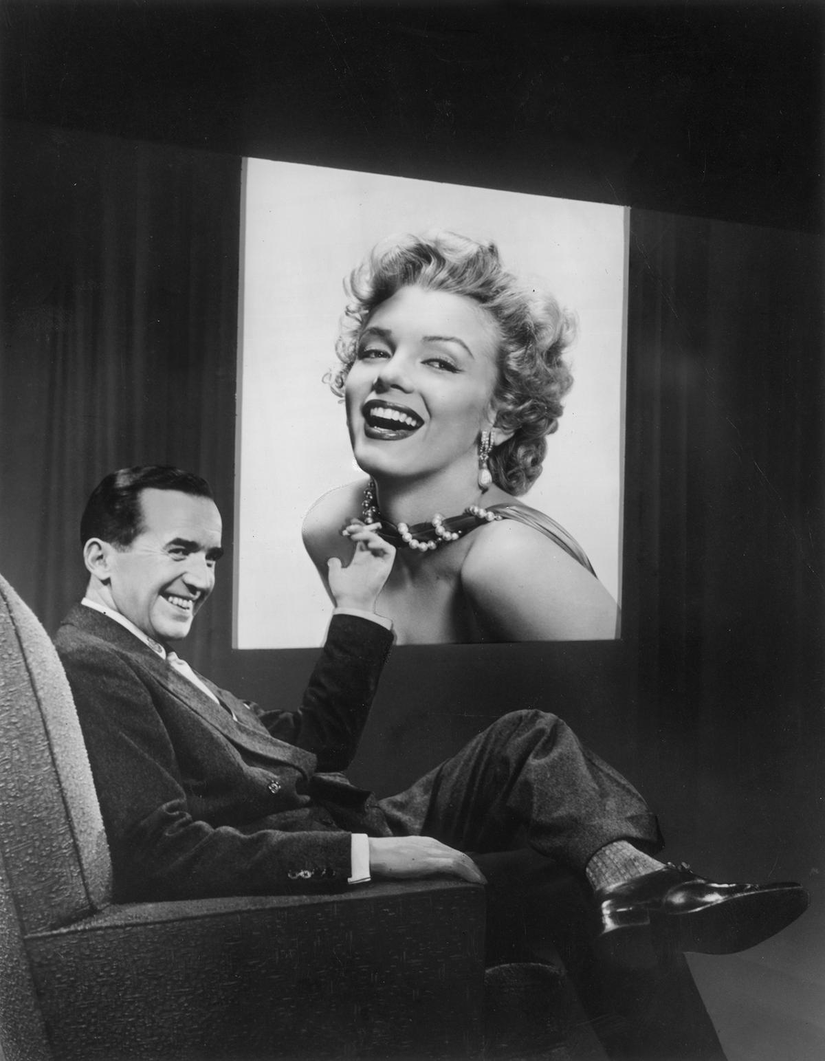 American broadcast journalist Edward R. Murrow points to an image of Marilyn Monroe who was scheduled for a television interview on '"Person to Person," 1955. (Hulton Archive/Getty Images)
