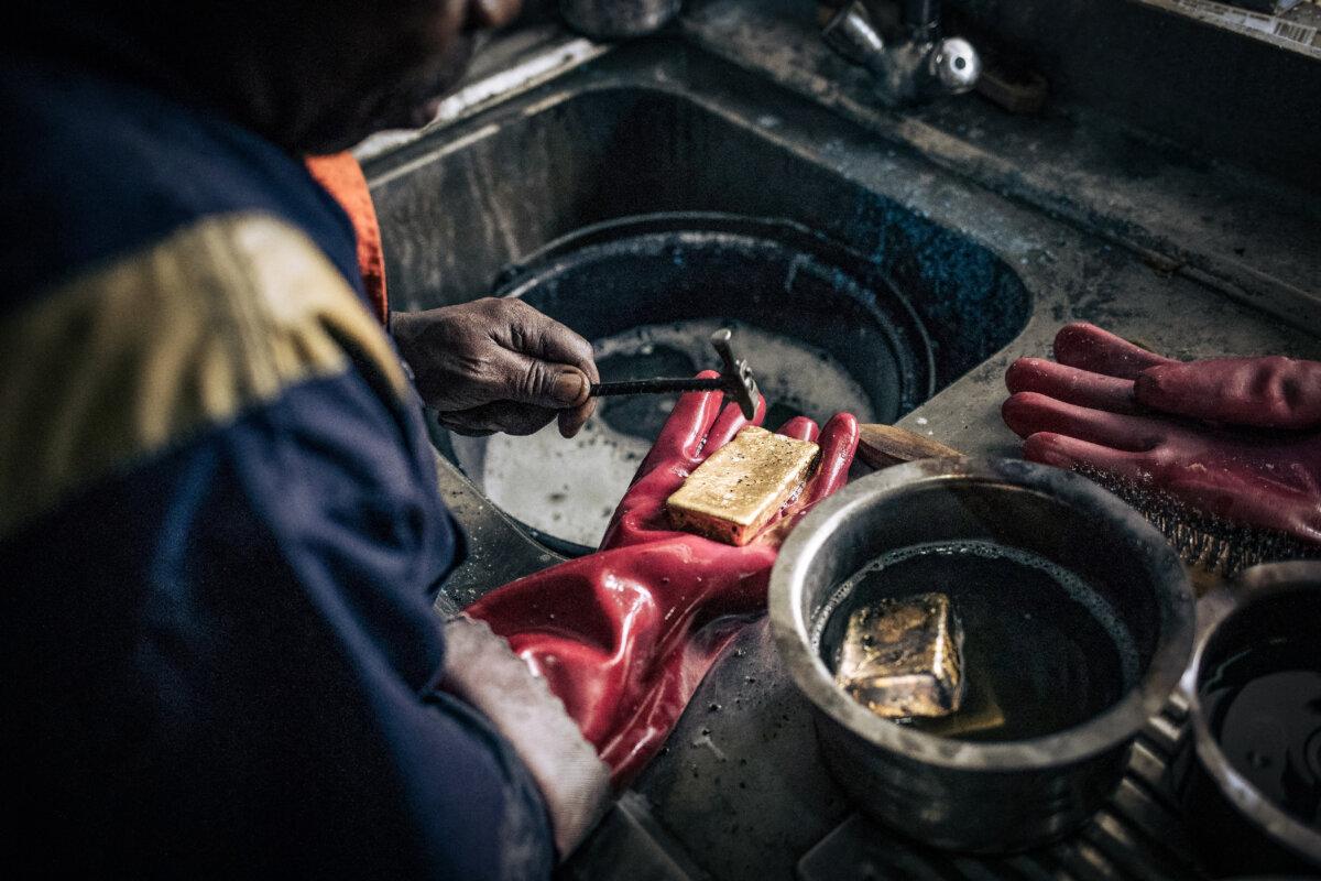 A technician cleans impurities from melted gold bars at Primera Gold's laboratory in Bukavu, Democratic Republic of Congo, on May 12, 2023. (Alexis Huguet/AFP via Getty Images)