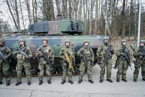 German soldiers stand in front of a Puma infantry fighting vehicle at the Bundeswehr Panzergrenadierbataillon 122 armored infantry battalion in Weiden, Germany, on February 28, 2024. (Leonhard Simon/Getty Images)