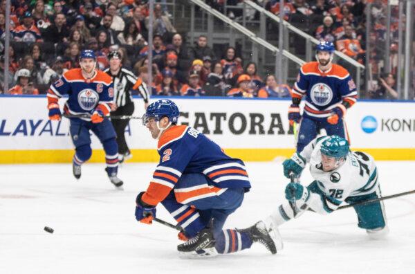 Oilers defenseman Evan Bouchard goes down to block a shot against the Sharks in Edmonton on April 15, 2024. (Jason Franson/The Canadian Press via AP)