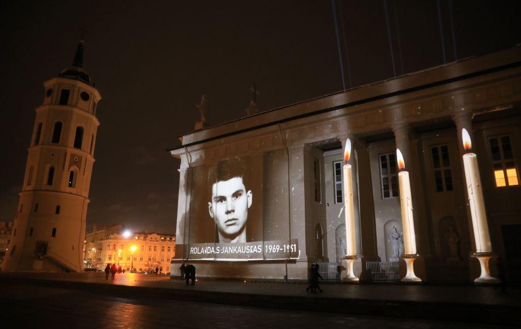 Portraits of the fallen are shown on Saint Stanislas and Saint Vladislav Cathedral, in the capital of Lithuania, Vilnius on the eve of the 30th anniversary of the stand against the Soviet forces, taken on Jan. 12, 2021. (Petras Malukas/AFP via Getty Images)