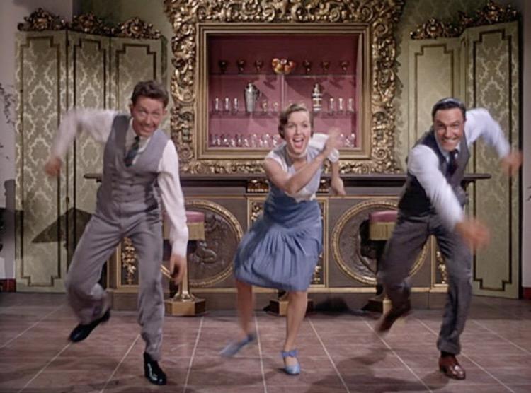 (L–R) Cosmo Brown (Donald O’Conner), Kathy Seldon (Debbie Reynolds), and Don Lockwood (Gene Kelly) dancing, in “Singin’ in the Rain.” (Metro-Goldwyn-Mayer)