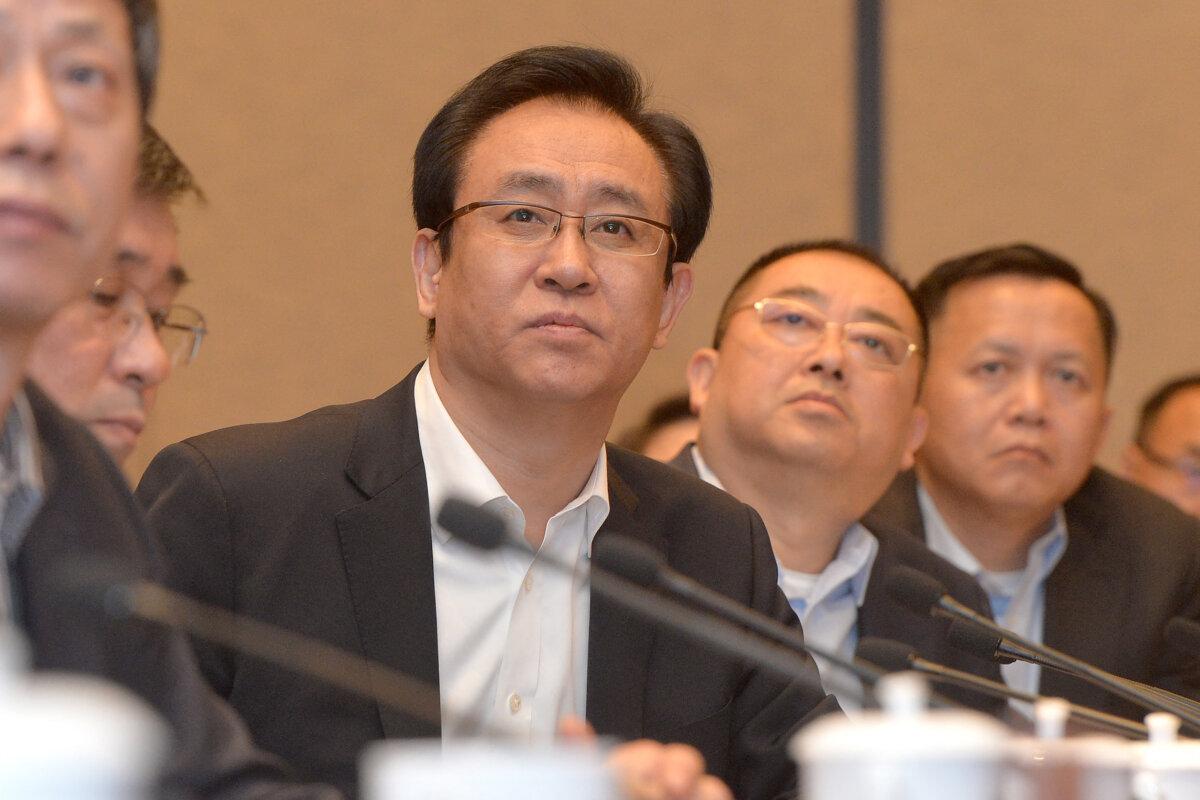 (C) Evergrande's president Xu Jiayin, also known as Hui Ka Yan in Cantonese, attending a meeting in Wuhan, in China's central Hubei province on June 5, 2017. (STR/AFP via Getty Images)