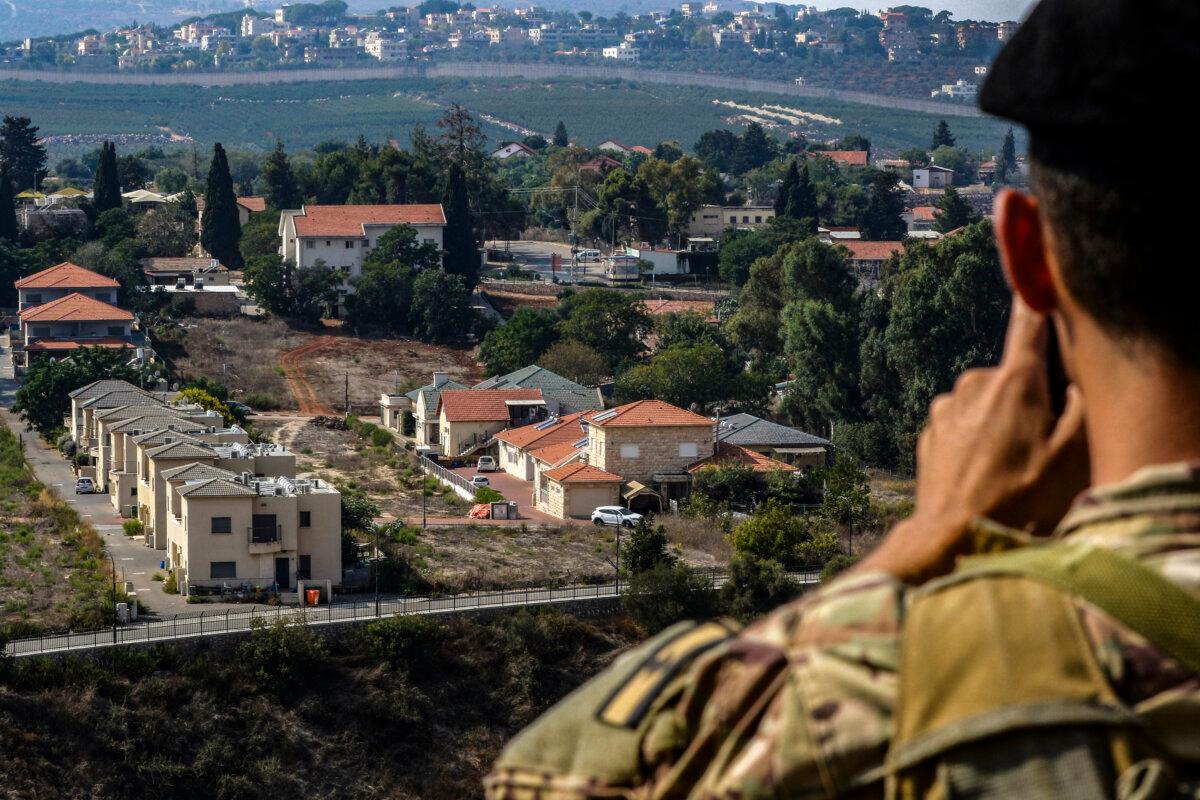 A Lebanese soldier monitors the border area with the northern Israeli town of Metula on Oct. 8, 2023. (MAHMOUD ZAYYAT/AFP via Getty Images)