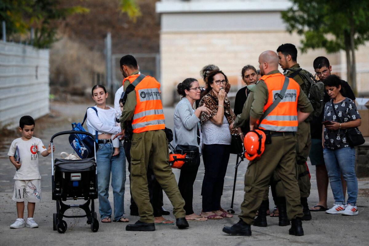 Israeli army soldiers help evacuate residents from the northern city of Kiryat Shmona near the Lebanon border on Oct. 20, 2023. (JALAA MAREY/AFP via Getty Images)