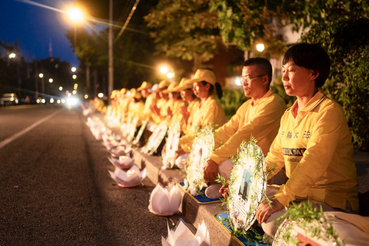 Falun Gong practitioners hold a candlelight vigil outside the Chinese Consulate in Toronto on July 20, 2024, to peacefully protest and mark the 25th anniversary of the regime’s persecution campaign. (Evan Ning/The Epoch Times)