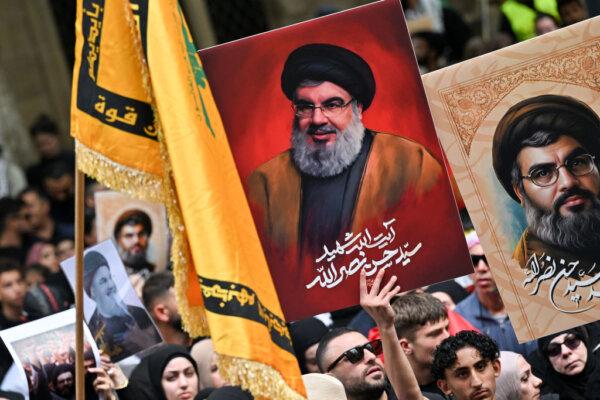 Demonstrators hold flags and pictures of Hassan Nasrallah, the late leader of the Lebanese group Hezbollah, at a protest rally in the central business district of Sydney, Australia on Sept. 29, 2024. (Saeed Khan/AFP via Getty Images)