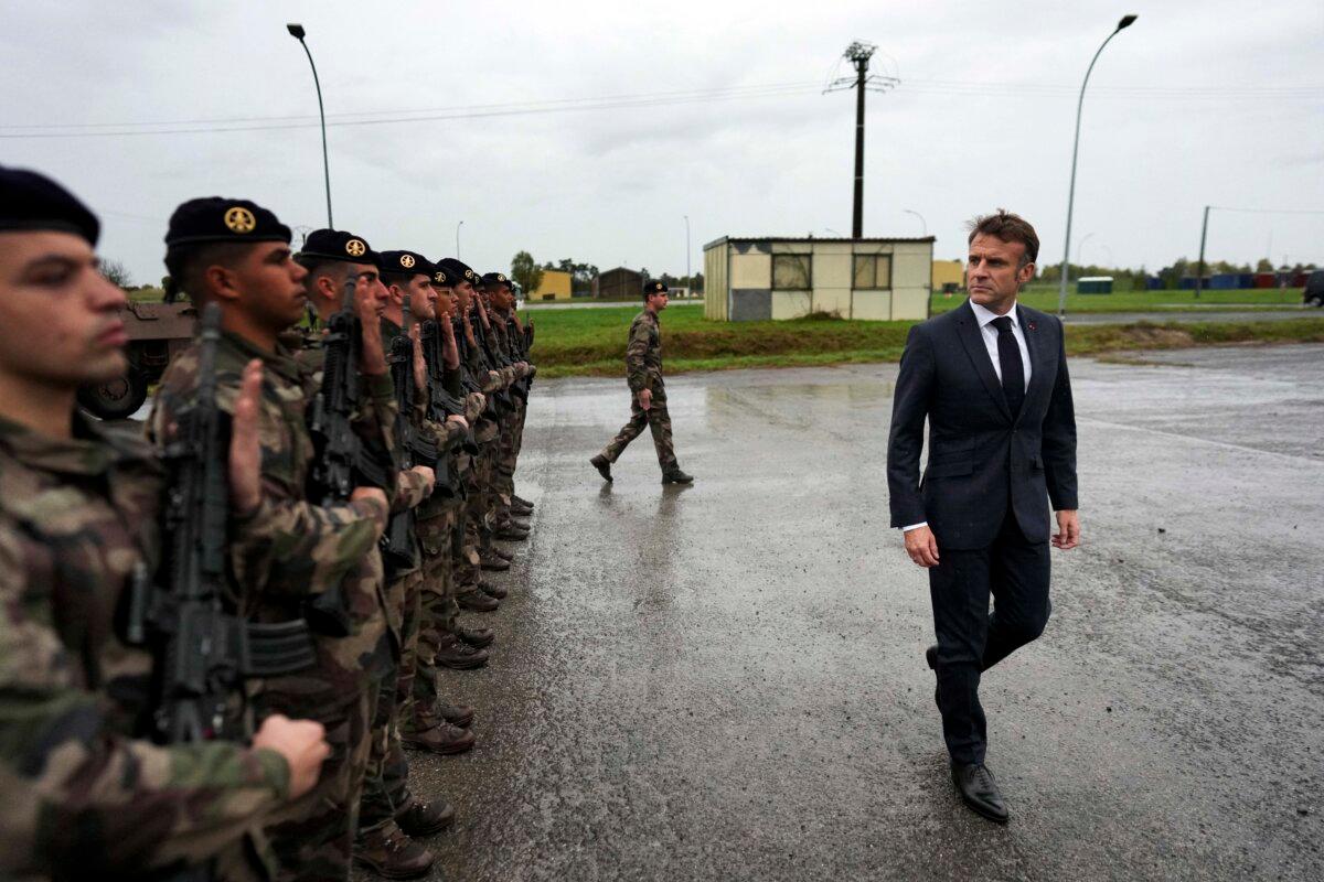 France's President Emmanuel Macron (R) reviews French troops during a visit to a military camp in eastern France on Oct. 9, 2024. (Thibault Camus/AFP via Getty Images)