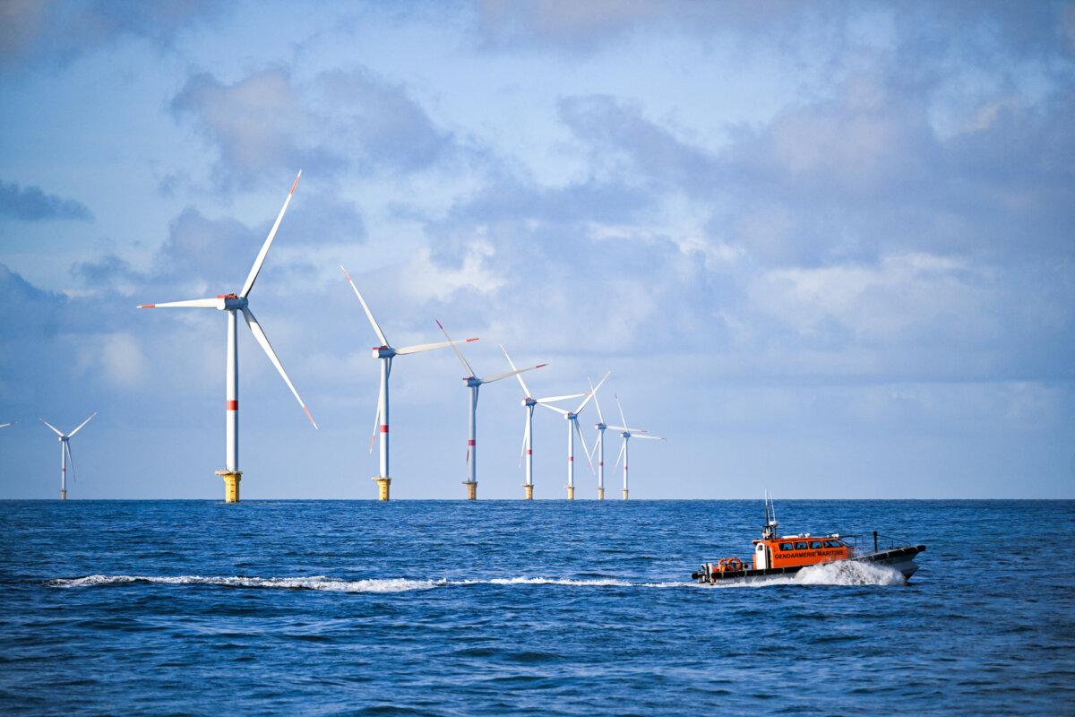 A gendarmerie maritime sails by a wind farm, off Fecamp, France, on Oct. 18, 2024. (Lou Benoist/AFP via Getty Images)