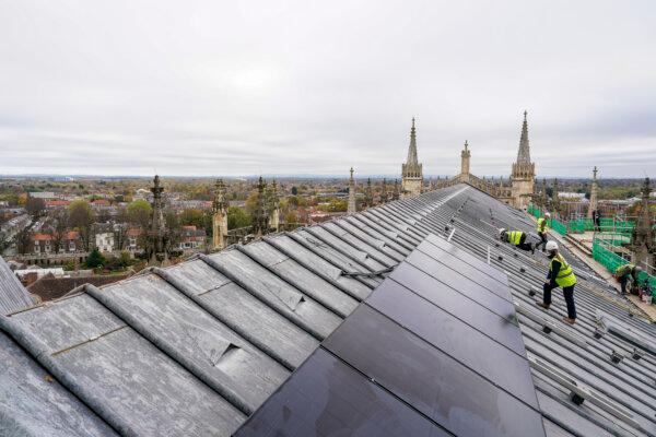 Engineers from Associated Clean Technologies work to attach solar panels to the roof of York Minster in England on Oct. 31, 2024. (Ian Forsyth/Getty Images)
