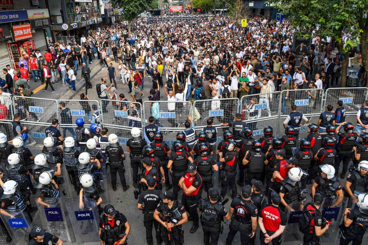 Turkish security forces stand behind barricades as protesters stage a rally organized by the pro-Kurdish Equality and Democracy (DEM) Party against the continued isolation of imprisoned PKK founder Abdullah Ocalan in Diyarbakir, Turkey, on Oct. 13, 2024. (Ilyas Akengin/AFP via Getty Images)