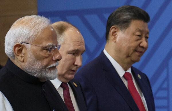 Indian Prime Minister Narendra Modi, Russian President Vladimir Putin, and Chinese President Xi Jinping arrive for a family photo during the BRICS summit in Kazan on Oct. 23, 2024. (Maxim Shipenkov/POOL/AFP)