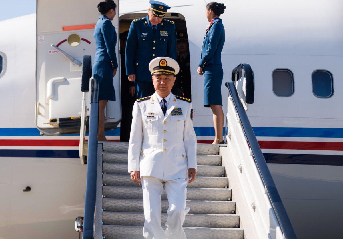 Adm. Miao Hua (C), China's director of the political affairs department of the Central Military Commission, disembarks his aircraft after arriving at Pyongyang International Airport on October 14, 2019. (Kim Won Jin/AFP via Getty Images)