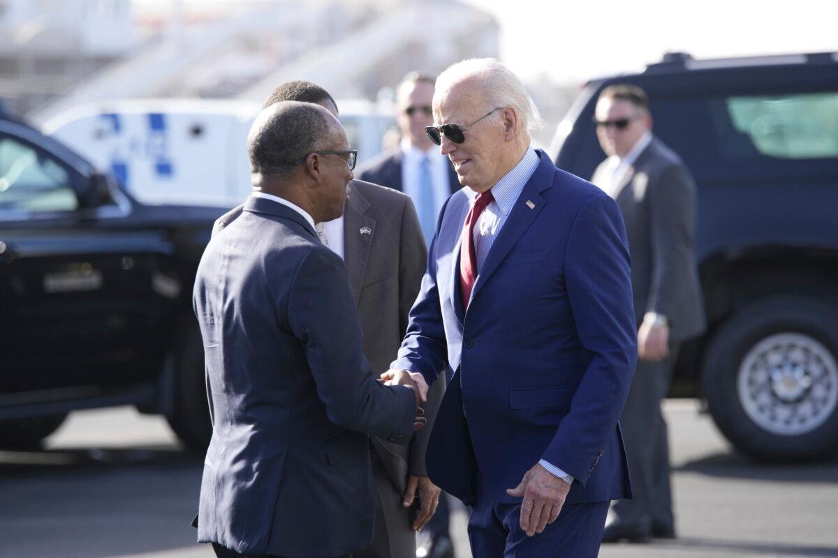 President Joe Biden (R) is greeted by Cape Verde's Prime Minister Ulisses Correia e Silva at Amilcar Cabral International Airport on Sal Island, Cape Verde, on Dec. 2, 2024. (Ben Curtis/AP Photo)