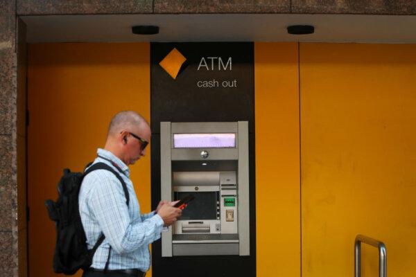 Pedestrians walk past a Commonwealth Bank of Australia (CBA) ATM in Sydney, Australia, on Feb. 26, 2024. (Lisa Maree Williams/Getty Images)