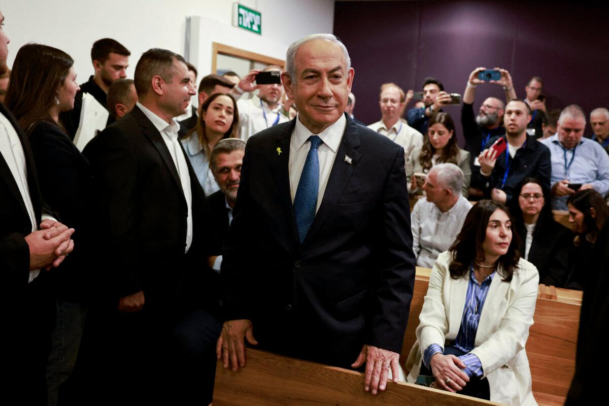 Israeli Prime Minister Benjamin Netanyahu smiles as he prepares to testify in his trial on corruption charges at the district court in Tel Aviv on Dec. 10, 2024. (MENAHEM KAHANA/POOL/AFP via Getty Images)