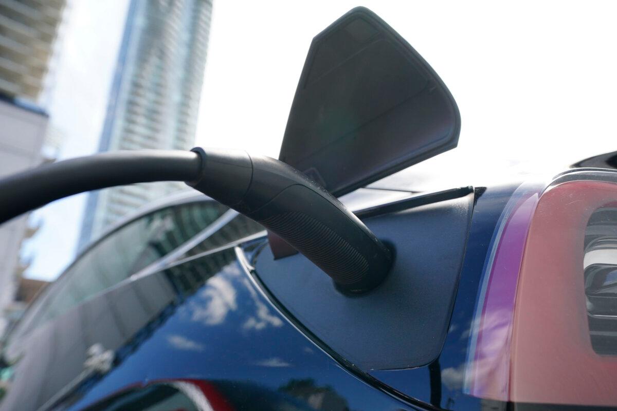 An electric vehicle is charged in Ottawa on July 13, 2022. (The Canadian Press/Sean Kilpatrick)