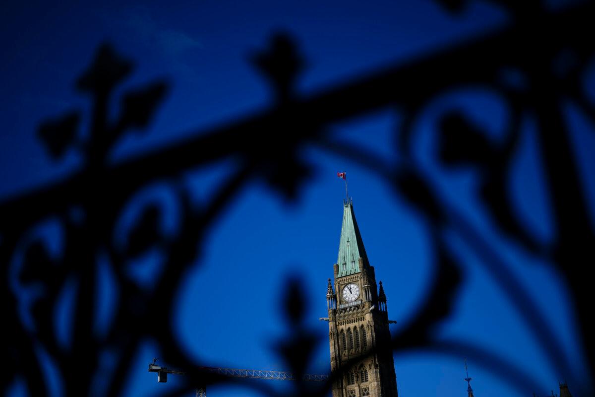 The Peace Tower is framed through the iron railing on Parliament Hill in Ottawa on Oct. 24, 2024. (The Canadian Press/Sean Kilpatrick)