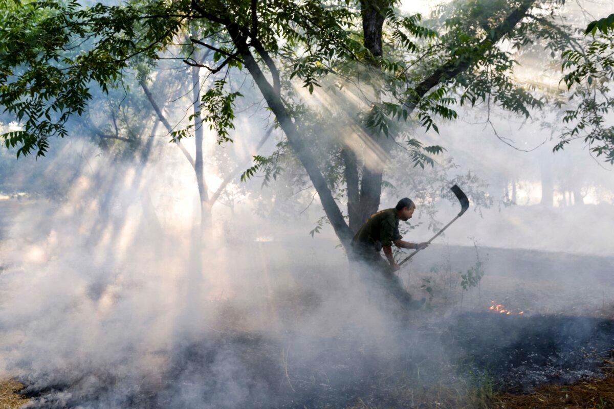 An Israeli first response unit puts out flames after a rocket strike from Lebanon into northern Israel, amid cross-border clashes between Israeli troops and fighters from the Hezbollah terrorist group in Kiryat Shmona, Israel, on June 4, 2024. (Jalaa Marey/AFP via Getty Images)