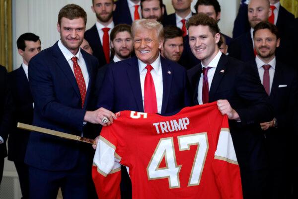 President Donald Trump receives a jersey and a hockey stick from Florida Panthers Matthew Tkachuk (R) and Aleksander Barkov (L) as he honored the 2024 Stanley Cup champions Florida Panthers at the White House on Feb. 3, 2025. (Kevin Dietsch/Getty Images)