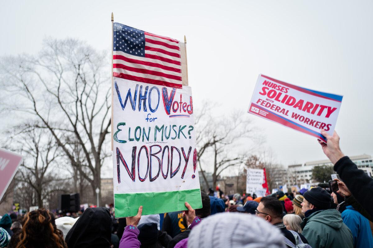 People protest the Department of Government Efficiency (DOGE) along with Democrat lawmakers on Capitol Hill in Washington on Feb. 11, 2025. (Madalina Vasiliu/The Epoch Times)
