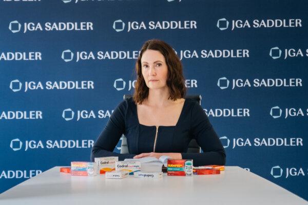 JGA Saddler Director Rebecca Jancauskas with some of the products the firm claims are ineffective. (Courtesy of JGA Saddler)