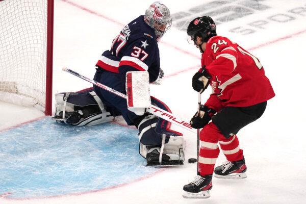 U.S. goalie Connor Hellebuyck (L) tops a shot by Canada's Seth Jarvis during the first period of the 4 Nations Face-Off championship hockey game in Boston on Feb. 20, 2025. (Charles Krupa/AP Photo)