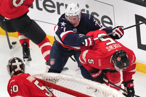 United States' Brady Tkachuk checks Canada's Devon Toews (5) during the first period of the 4 Nations Face-Off championship hockey game, in Boston on Feb. 20, 2025. (AP Photo/Charles Krupa)