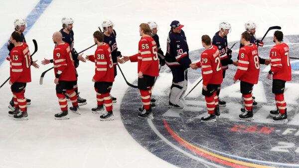 Canadian and American players shake hands following an overtime period of the 4 Nations Face- Off hockey game, in Boston on Feb. 20, 2025. (AP Photo/Charles Krupa)