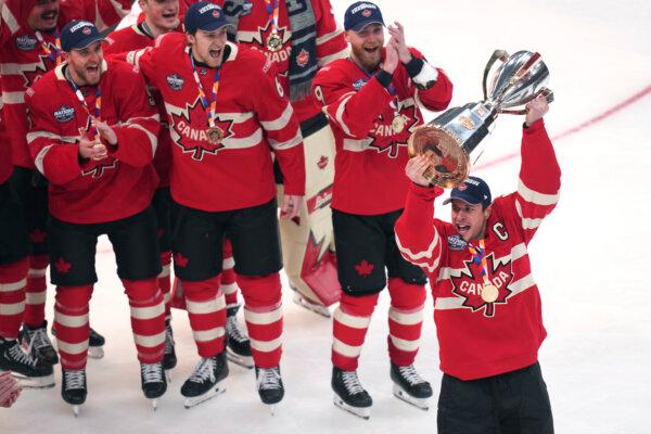 Canadian team captain Sidney Crosby hoists the trophy after defeating the United States following an overtime period of the 4 Nations Face-Off hockey game, in Boston on Feb. 20, 2025. (AP Photo/Charles Krupa)