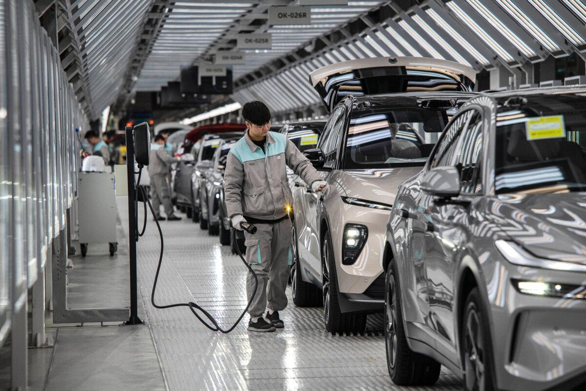 A worker inspects a vehicle's charging system in Hefei, China, on Jan. 17, 2025. (Kevin Frayer/Getty Images)