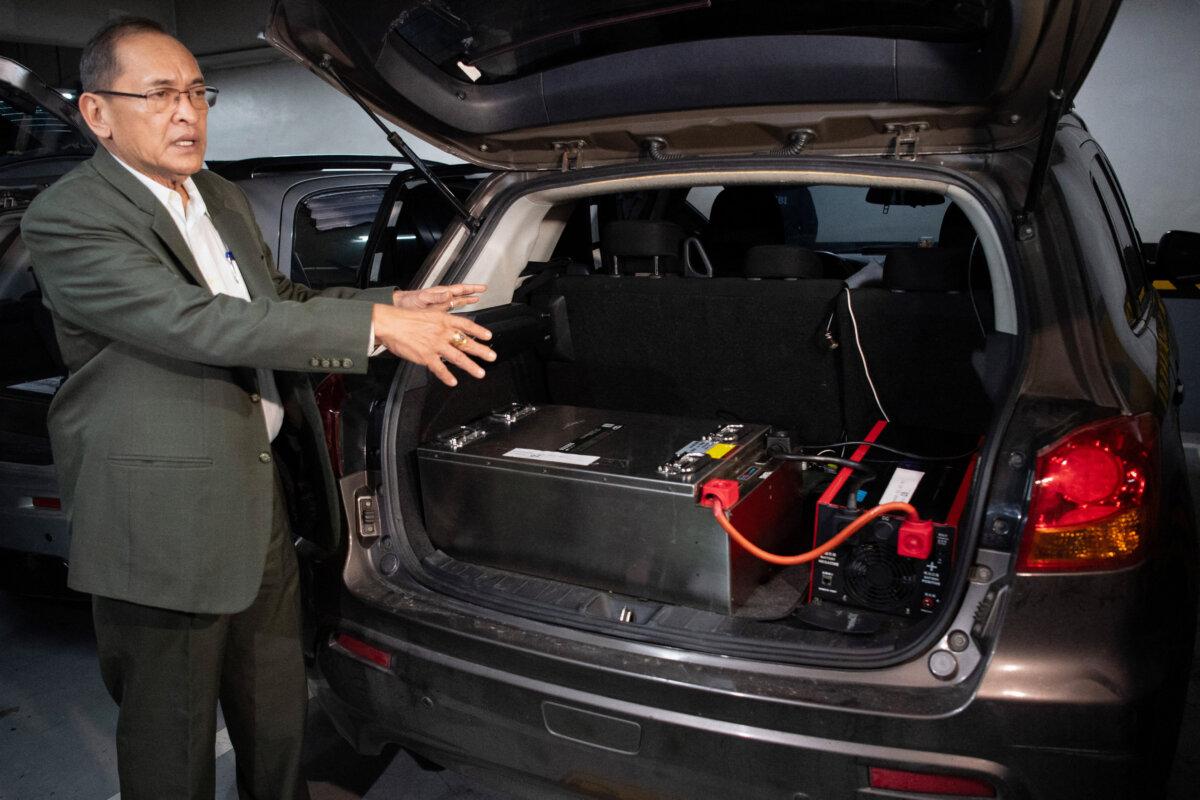 National Bureau of Investigation (NBI) Chief Jaime Santiago gestures beside a confiscated vehicle containing equipment during a press presentation of Chinese nationals and their Philippine accomplices, arrested for alleged espionage, at the NBI office in Manila on Feb. 25, 2025. (TED ALJIBE/AFP via Getty Images)