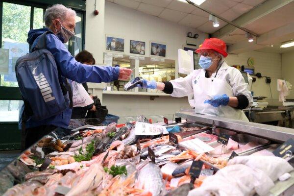 A customer uses a bank card to pay for his purchase in Cardiff, the UK, on Oct. 20, 2020. (Geoff Caddick/AFP via Getty Images)