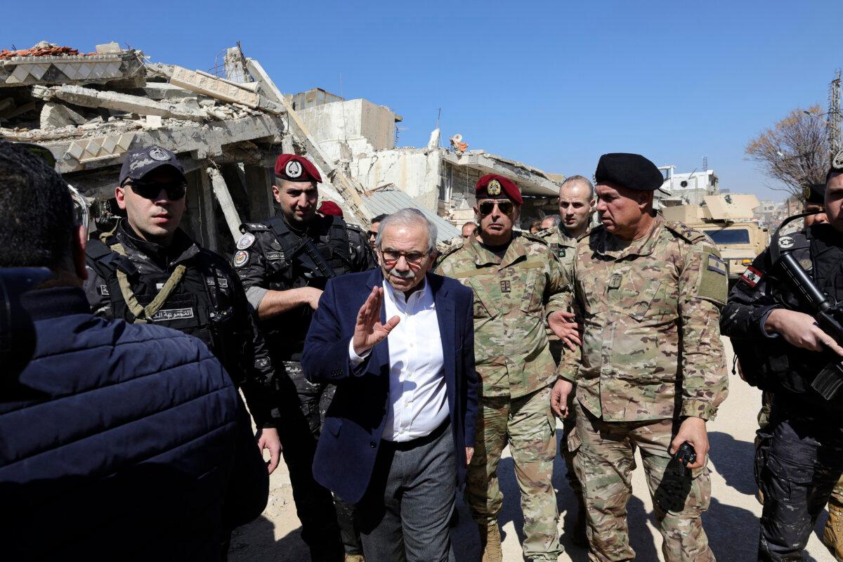 Lebanon's Prime Minister Nawaf Salam walks among Lebanese army soldiers as he visits the southern village of Khiam near the border with Israel, on Feb. 28, 2025, after the withdrawal last December of Israeli forces from the area under a cease-fire deal with Hezbollah. (Rabih Daher/AFP via Getty Images)