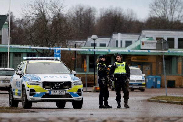 Police officers stand near the Risbergska school, following a deadly shooting attack at the adult education center in Orebro, Sweden, on Feb. 5, 2025. (Kuba Stezycki/Reuters)