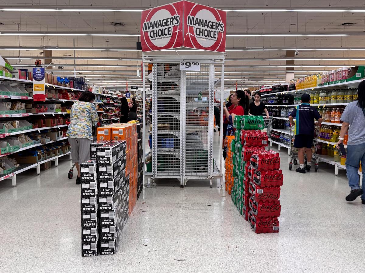 Customers rush to buy bottled water at a Coles supermarket store at Sunnybank Hills in Brisbane, Australia on March 3, 2025, as residents prepare for Cyclone Alfred. (Daniel Y. Teng/The Epoch Times)