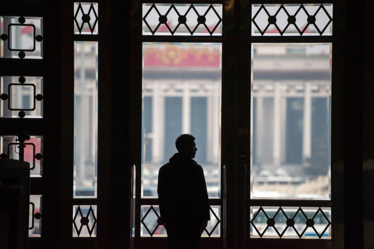 A Chinese soldier stands at the gate during the second plenary session of the first session of the 13th National People's Congress (NPC) at the Great Hall of the People in Beijing on March 9, 2018. (Fred Dufour/AFP via Getty Images)