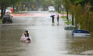 Day in Photos: Flooding in Australia, Confrontation Outside White House, Rally in Syria