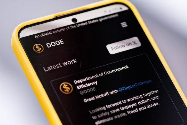 The Department of Government Efficiency (DOGE) website is displayed on a phone. (Oleksii Pydsosonnii/The Epoch Times)