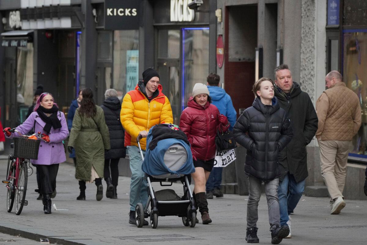 People walk along a shopping street in the center of Helsinki, Finland, on March 15, 2025. (Sergei Grits/AP Photo)