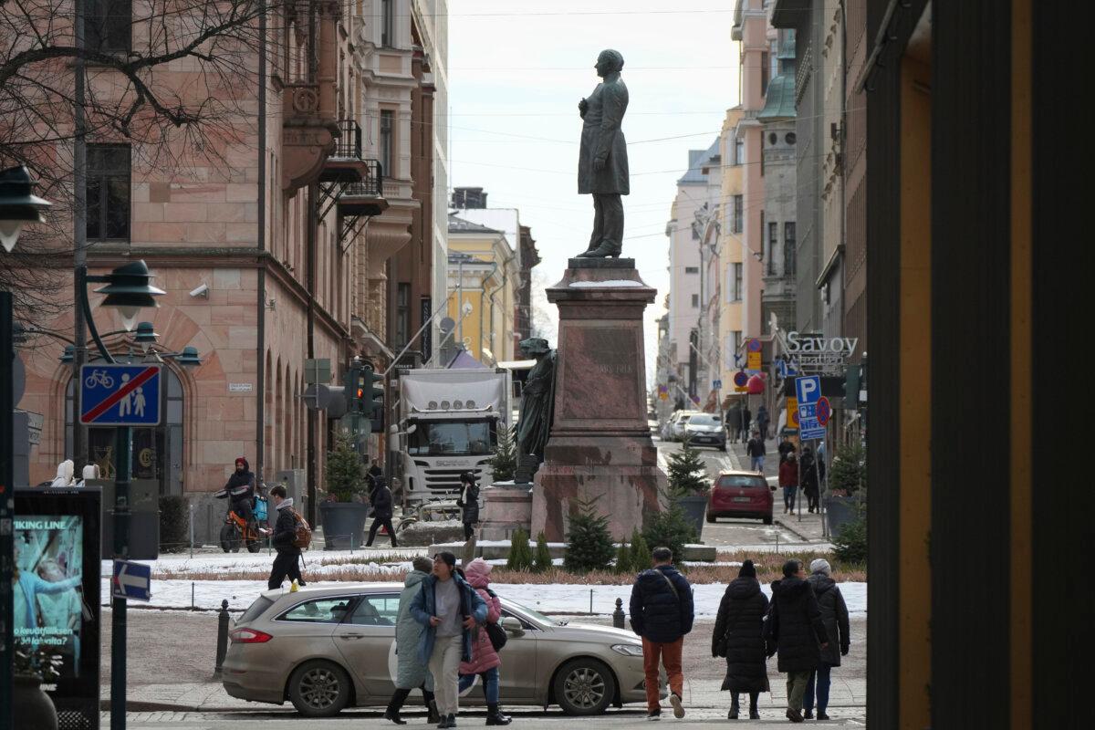 People walk past a monument to poet and writer Johan Ludvig Runeberg in Helsinki, Finland, on March 15, 2025. (Sergei Grits/AP Photo)