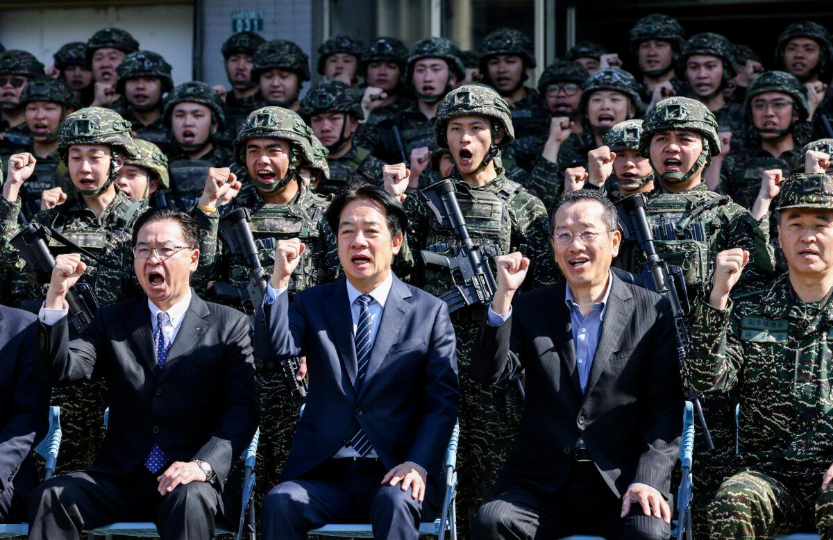(L-R) Taiwan's National Security Council Secretary-General Joseph Wu, Taiwan's President Lai Ching-te, and Taiwan's Defence Minister Wellington Koo pose for photos with soldiers as they visit the troops during the Rapid Response Exercise at the Songshan military airbase in Taipei, Taiwan, on March 21, 2025. (I-Hwa Cheng/AFP via Getty Images)