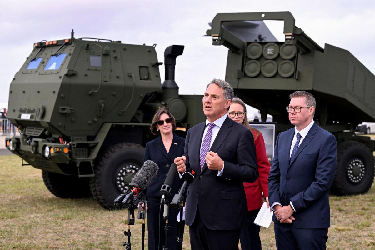 Australia's Minister of Defence Richard Marles (C) and Minister of Defence Industry and Capability Delivery Pat Conroy (R) announce the accelerated delivery of Australia's first High Mobility Artillery Rocket System (HIMARS) at the Australian International Airshow in Avalon on March 24, 2025. The country's acquisition of the HIMARS system was accelerated after a 2023 Defence Strategic Review. (Photo by WILLIAM WEST/AFP via Getty Images)